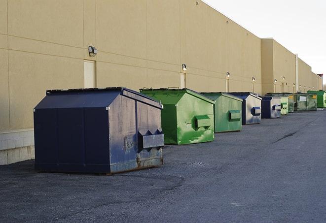 a construction worker disposing of debris into a dumpster in Castle Rock, MN